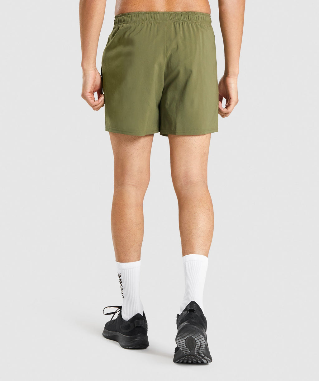 gymshark-arrival-5-shorts-dark-green-white-logo