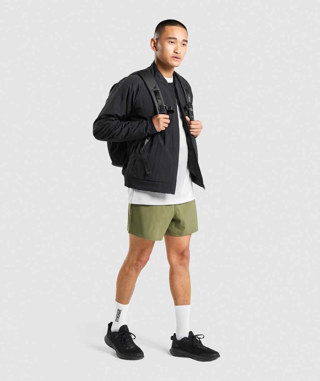 gymshark-arrival-5-shorts-dark-green-white-logo