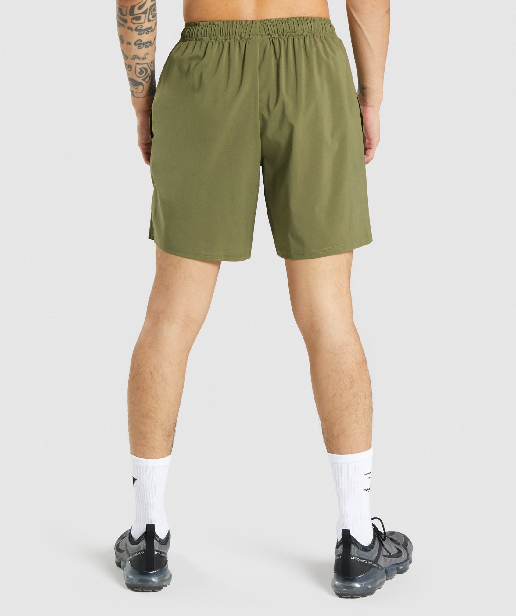 gymshark-arrival-shorts-dark-green-white-logo