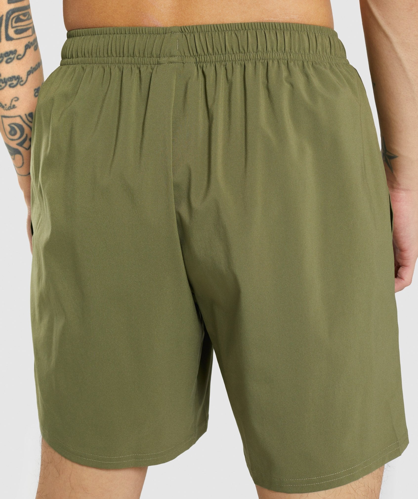 gymshark-arrival-shorts-dark-green-white-logo