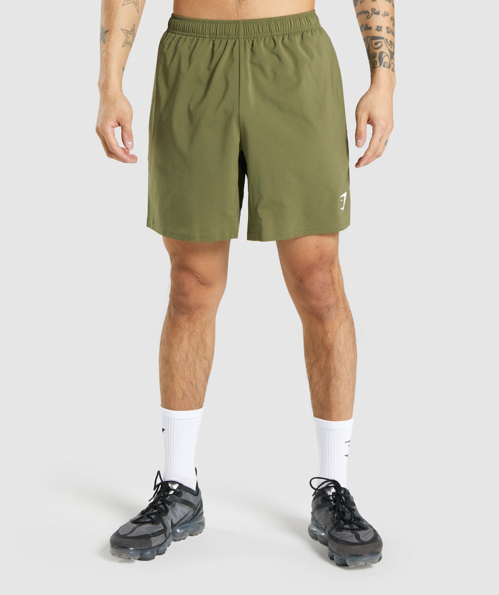 gymshark-arrival-shorts-dark-green-white-logo