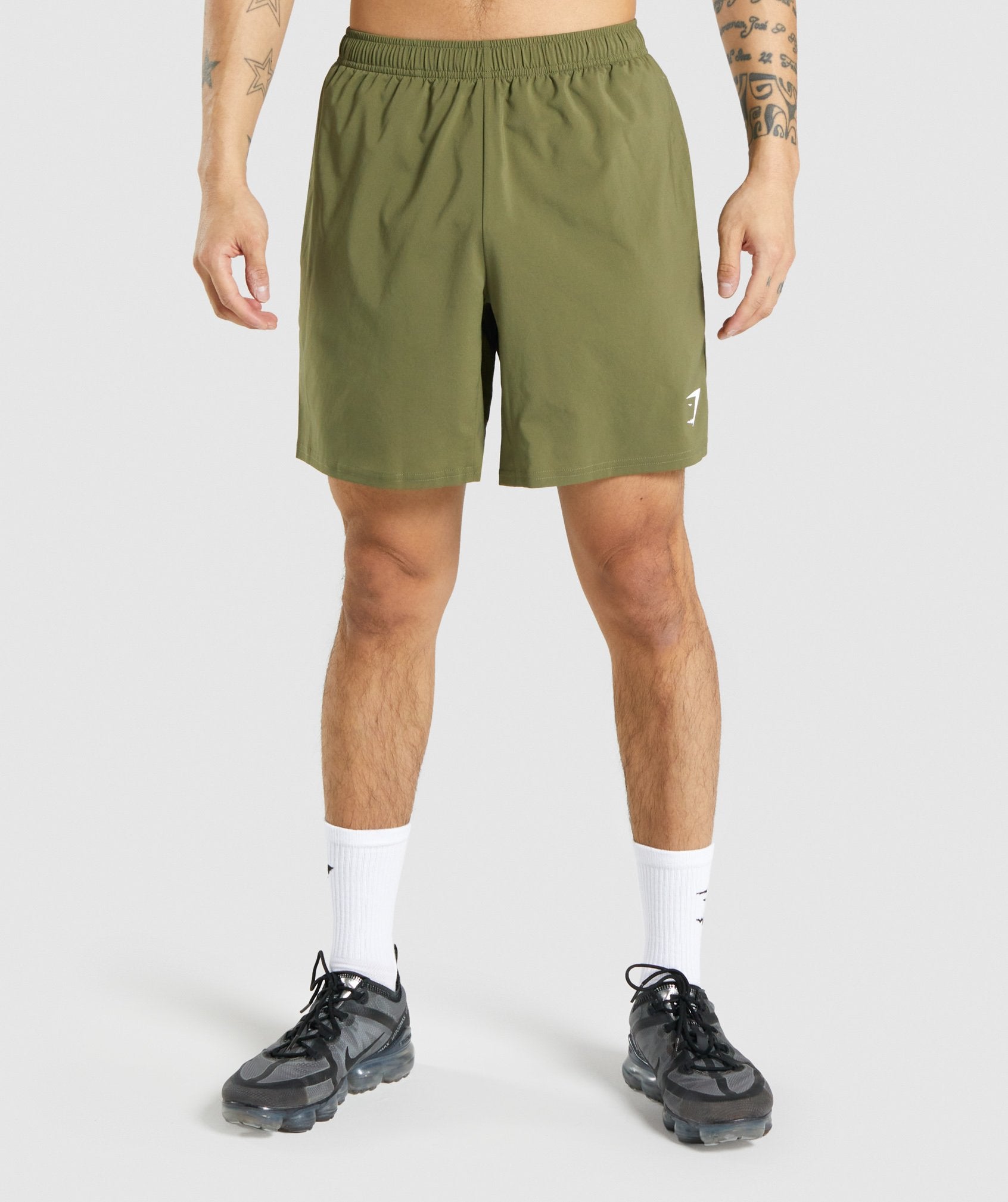 gymshark-arrival-shorts-dark-green-white-logo