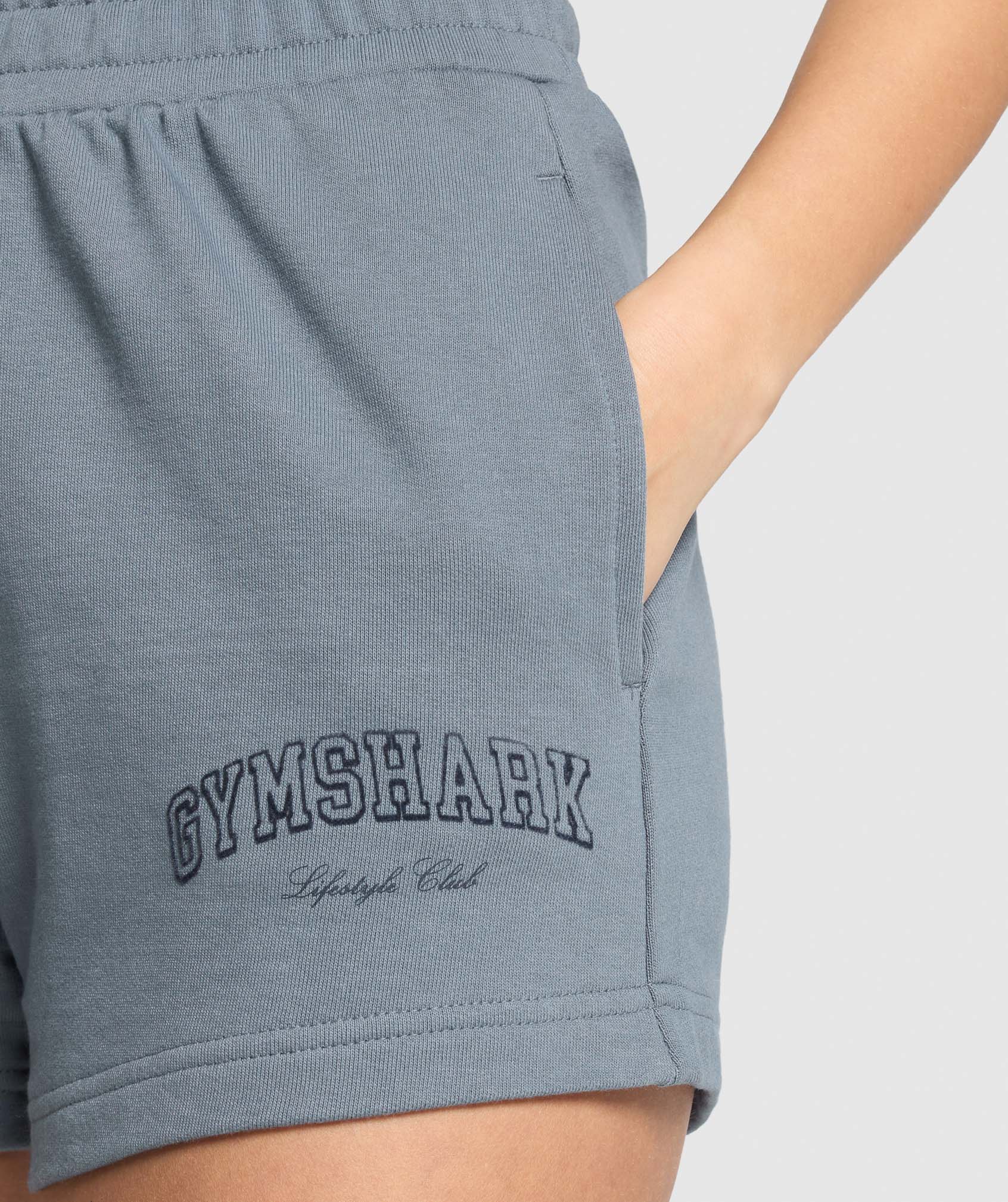 gymshark-campus-classics-graphic-sweat-shorts-iron-blue-ss25