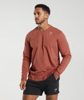 gymshark-crest-long-sleeve-t-shirt-persimmon-red-ss23