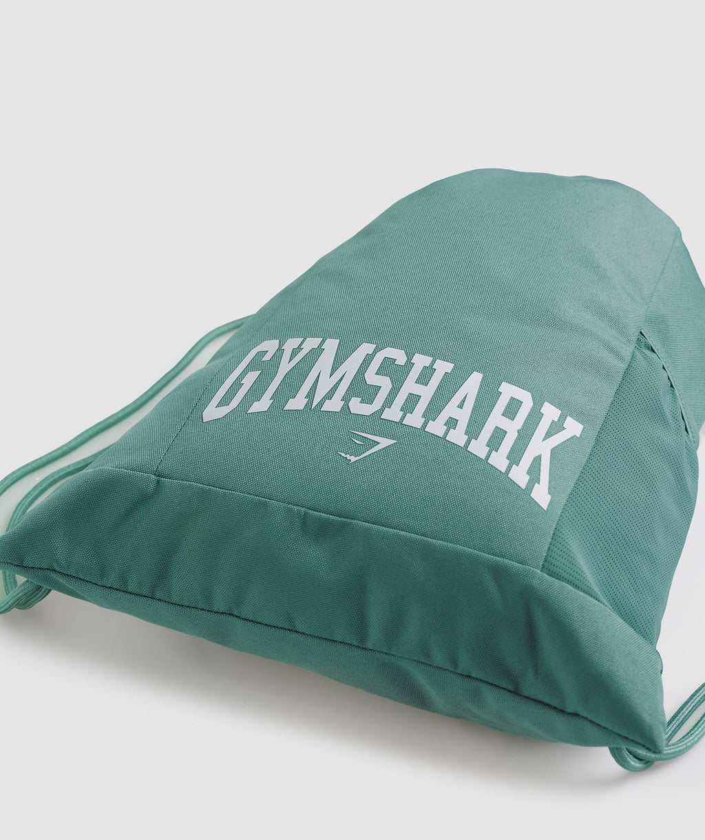 gymshark-gfx-collegiate-gymsack-ink-teal-ss23