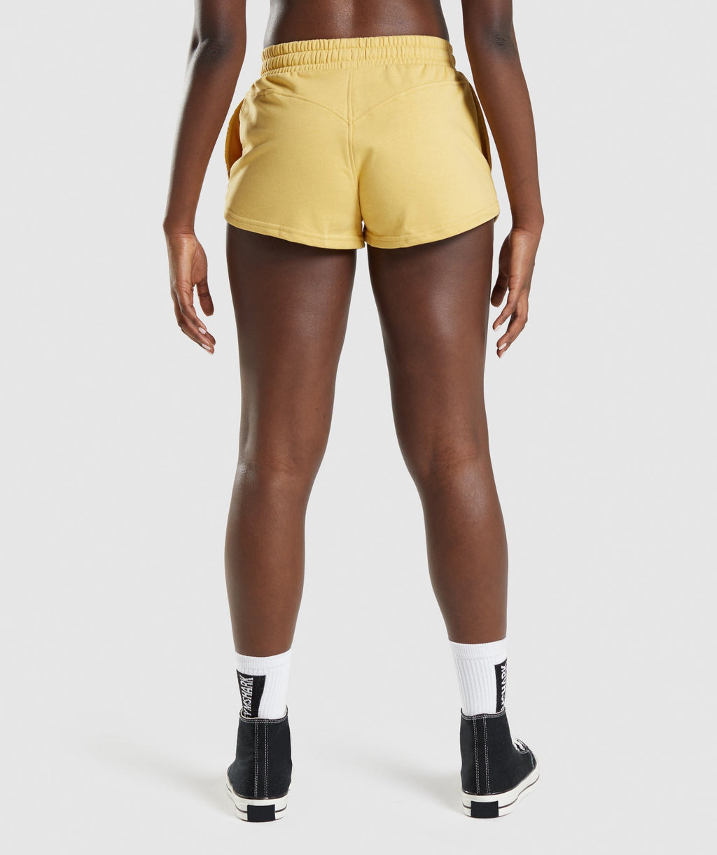 gymshark-legacy-graphic-shorts-yellow-aw21