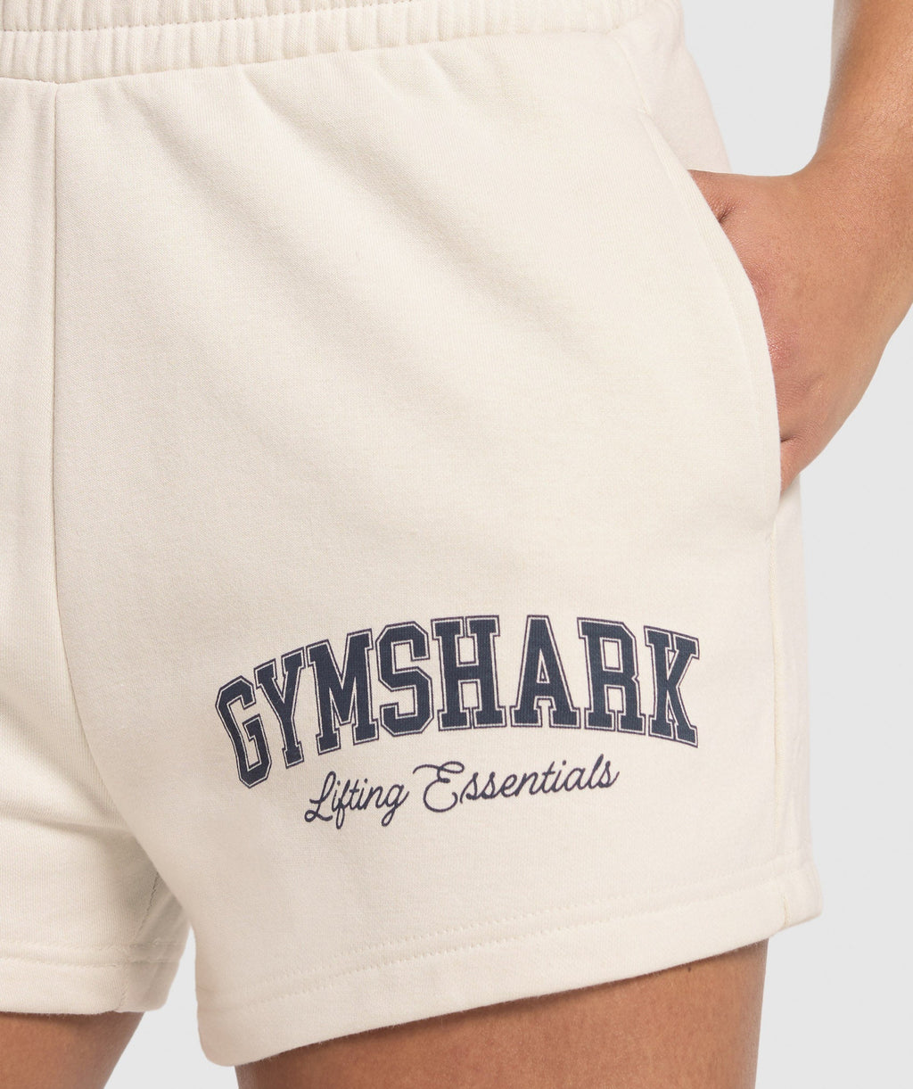 gymshark-lifting-essentials-graphic-brushed-4-shorts-oat-white-ss25