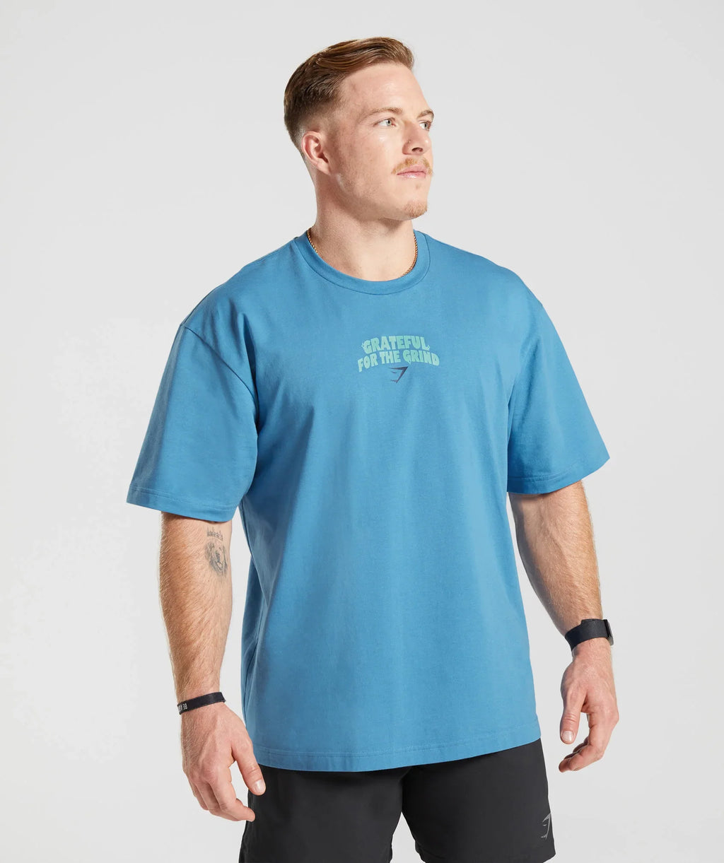 gymshark-noah-ohlsen-oversized-sun-t-shirt-coastal-blue-ss23