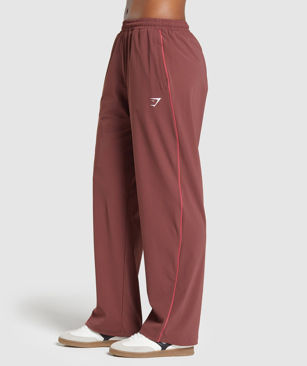 gymshark-stitch-feature-woven-pants-burgundy-brown-ss24