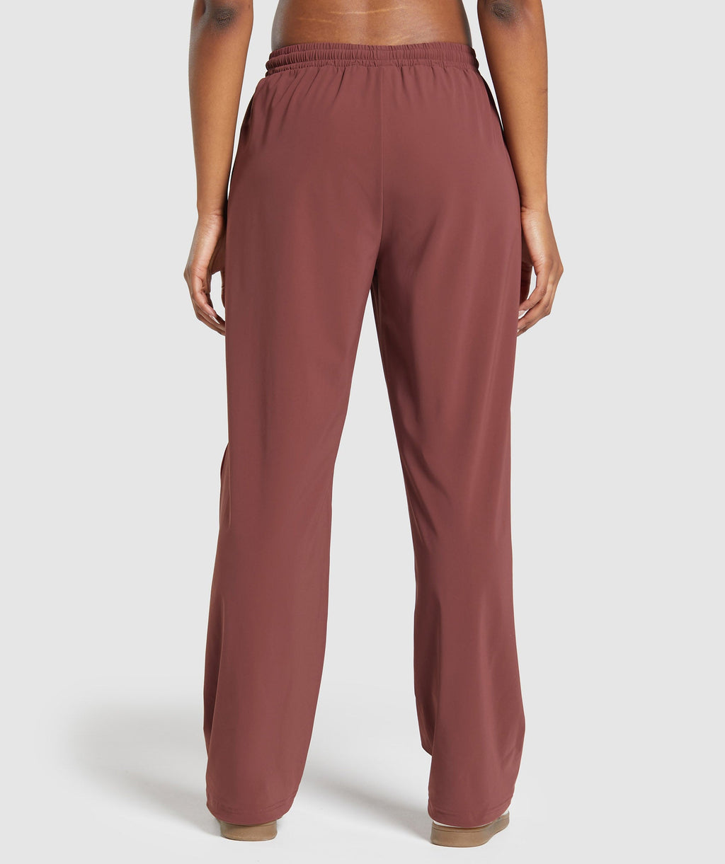gymshark-stitch-feature-woven-pants-burgundy-brown-ss24