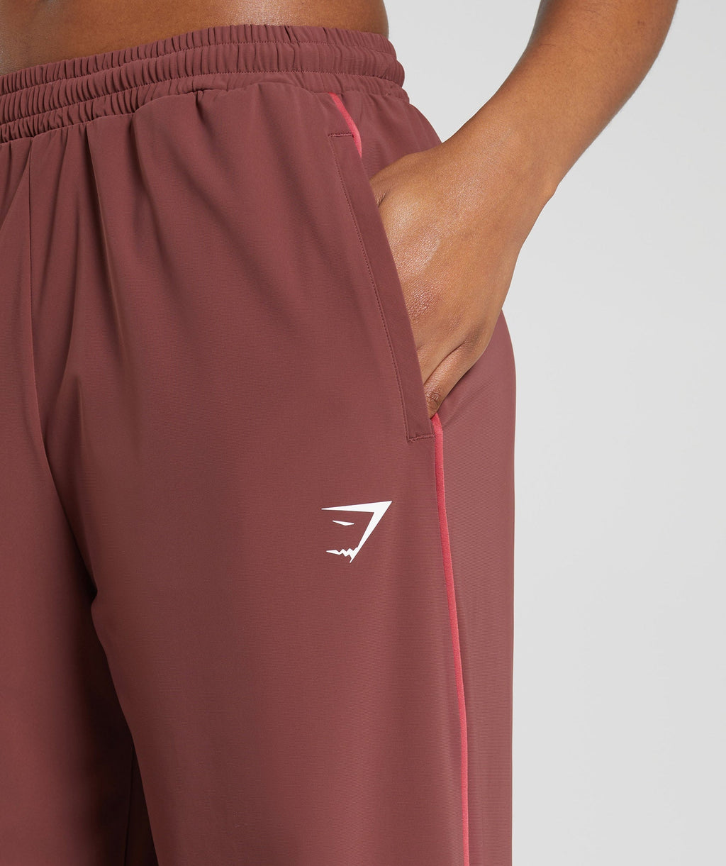 gymshark-stitch-feature-woven-pants-burgundy-brown-ss24