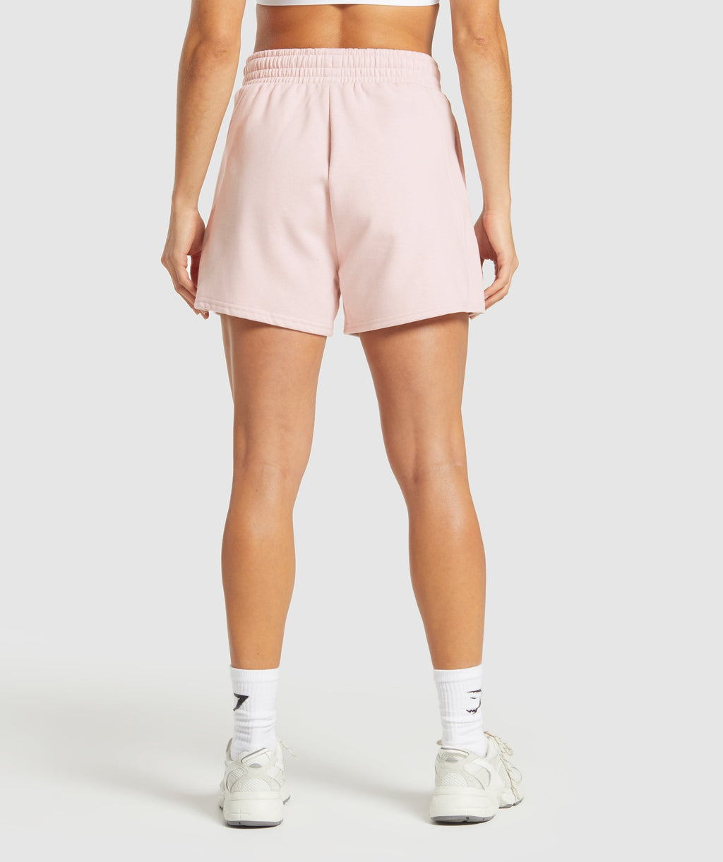 gymshark-training-fleece-shorts-fair-pink-ss25