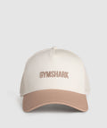 gymshark-wordmark-trucker-cap-oat-white-deep-fawn-brown-ss25