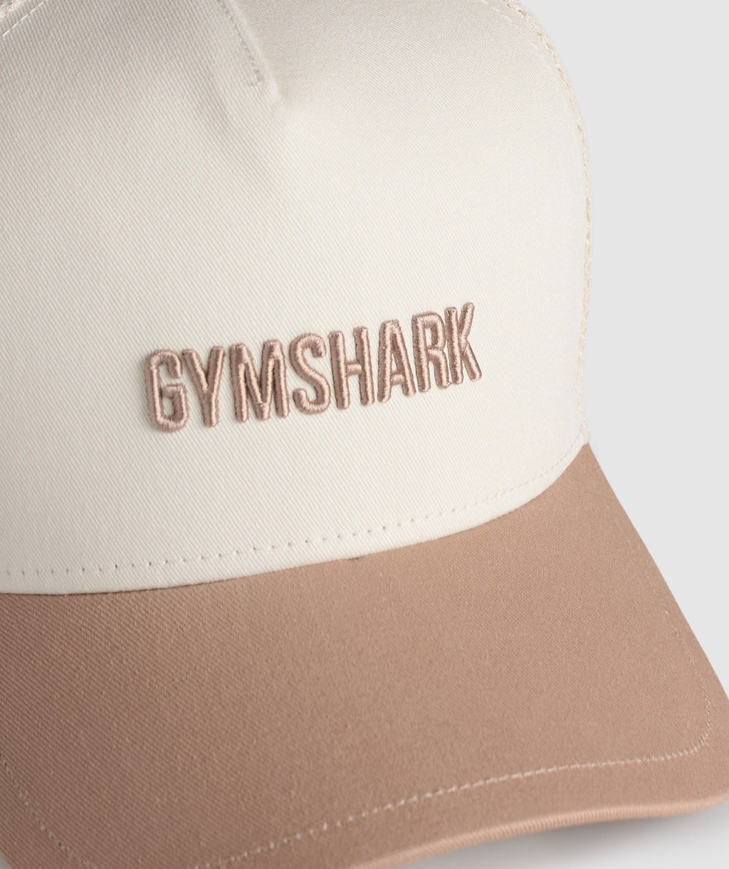 gymshark-wordmark-trucker-cap-oat-white-deep-fawn-brown-ss25