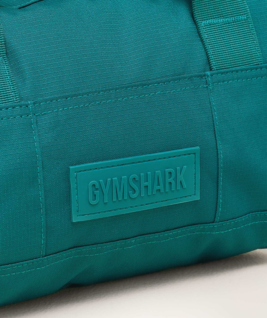 gymshark-active-holdall-mini-bags-teal-ss25