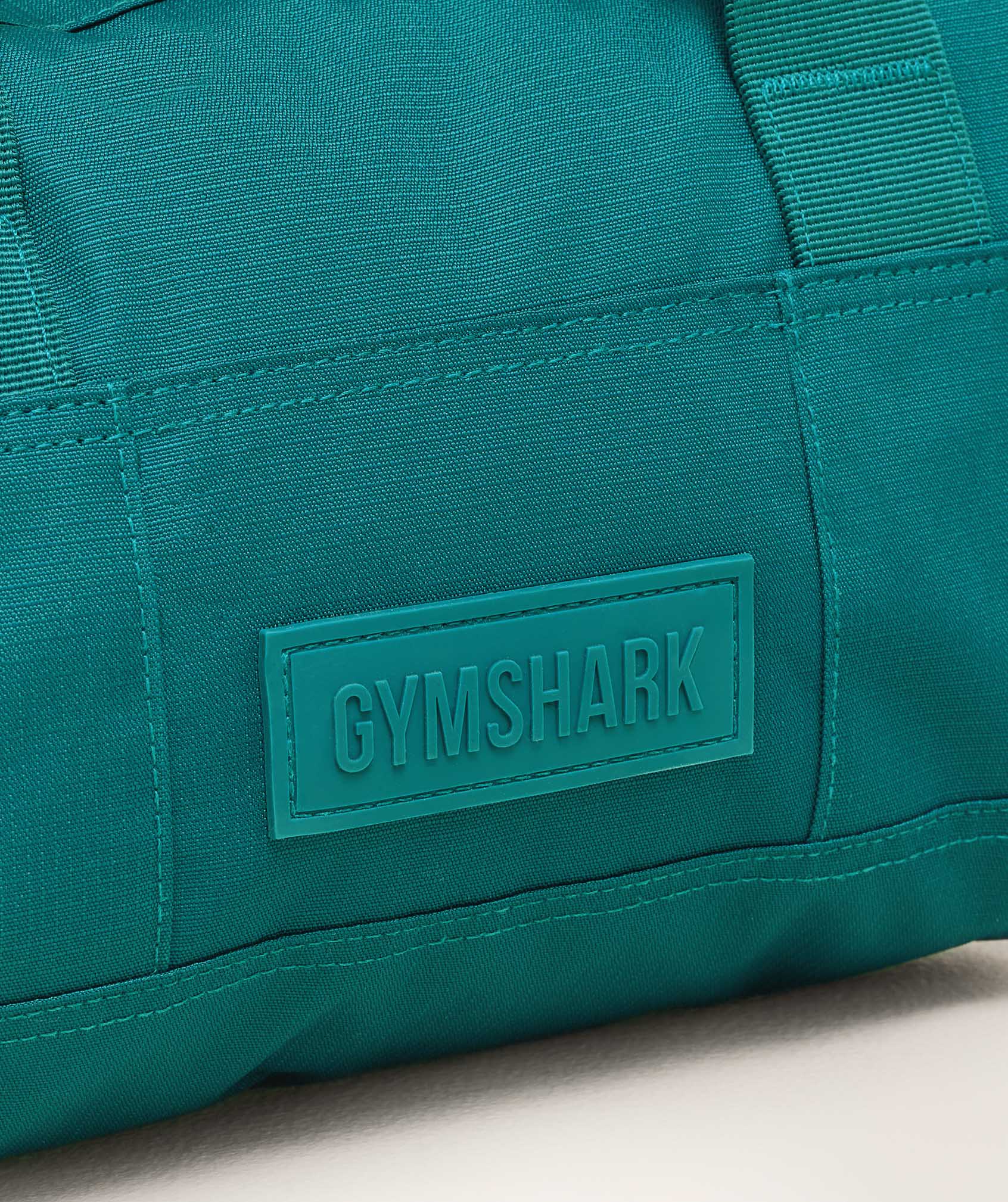 gymshark-active-holdall-mini-bags-teal-ss25