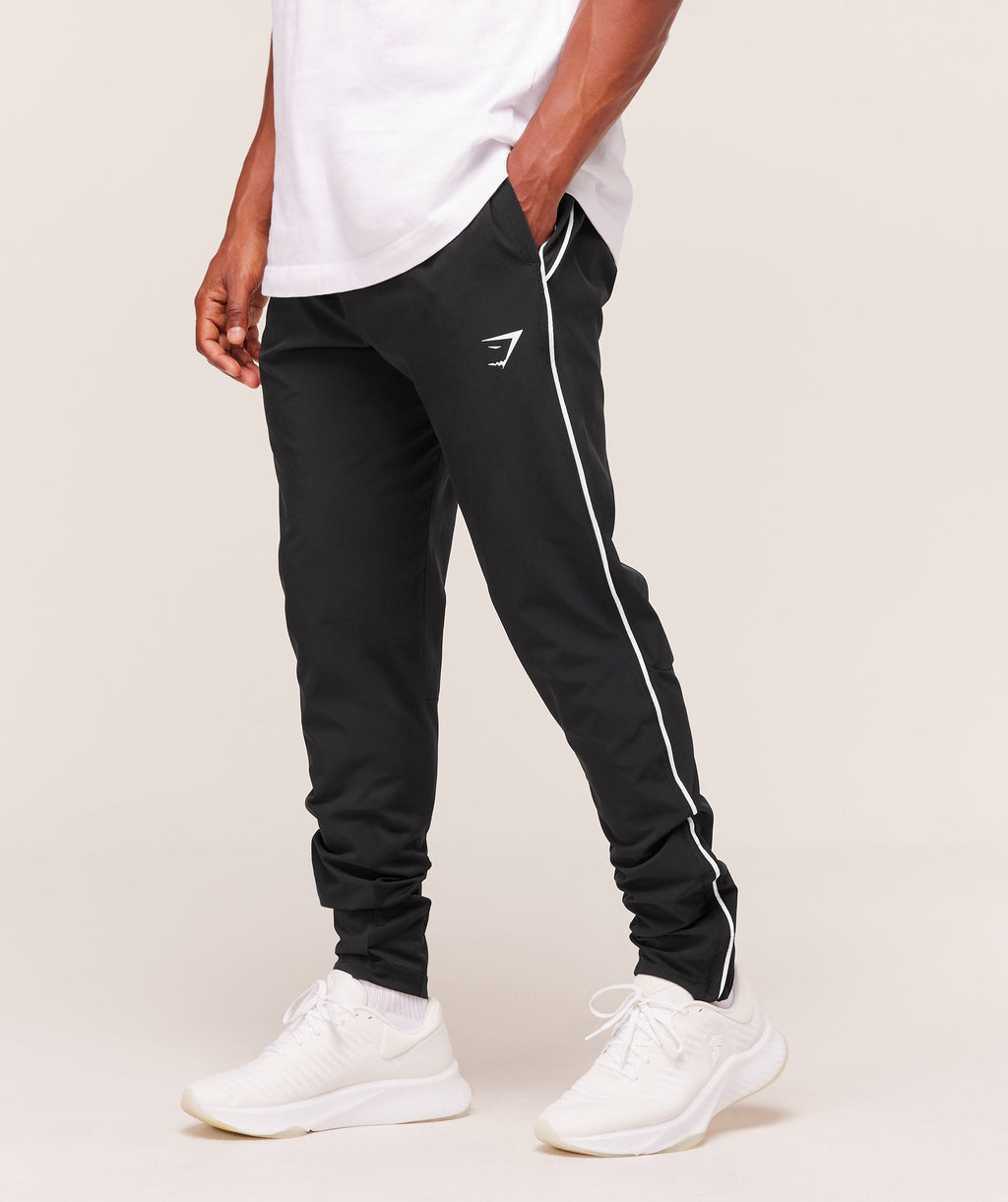 gymshark-arrival-woven-block-joggers-pants-black-aw25