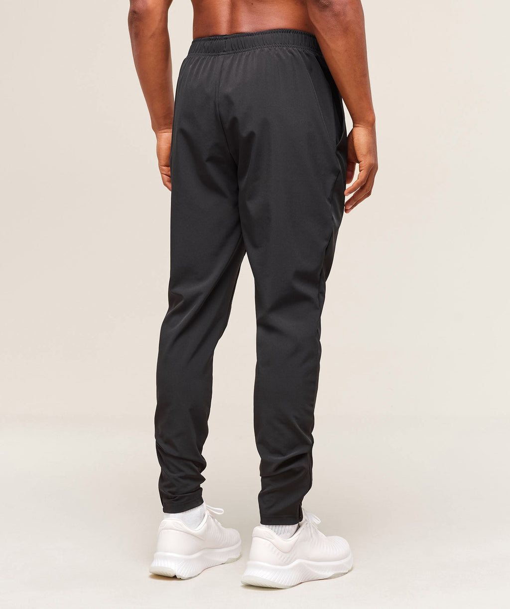 gymshark-arrival-woven-tall-joggers-black-ss25
