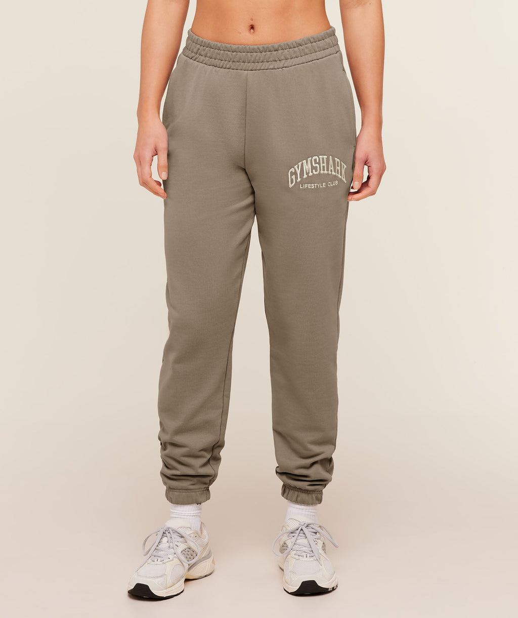 gymshark-collegiate-graphic-joggers-pants-brown-aw25