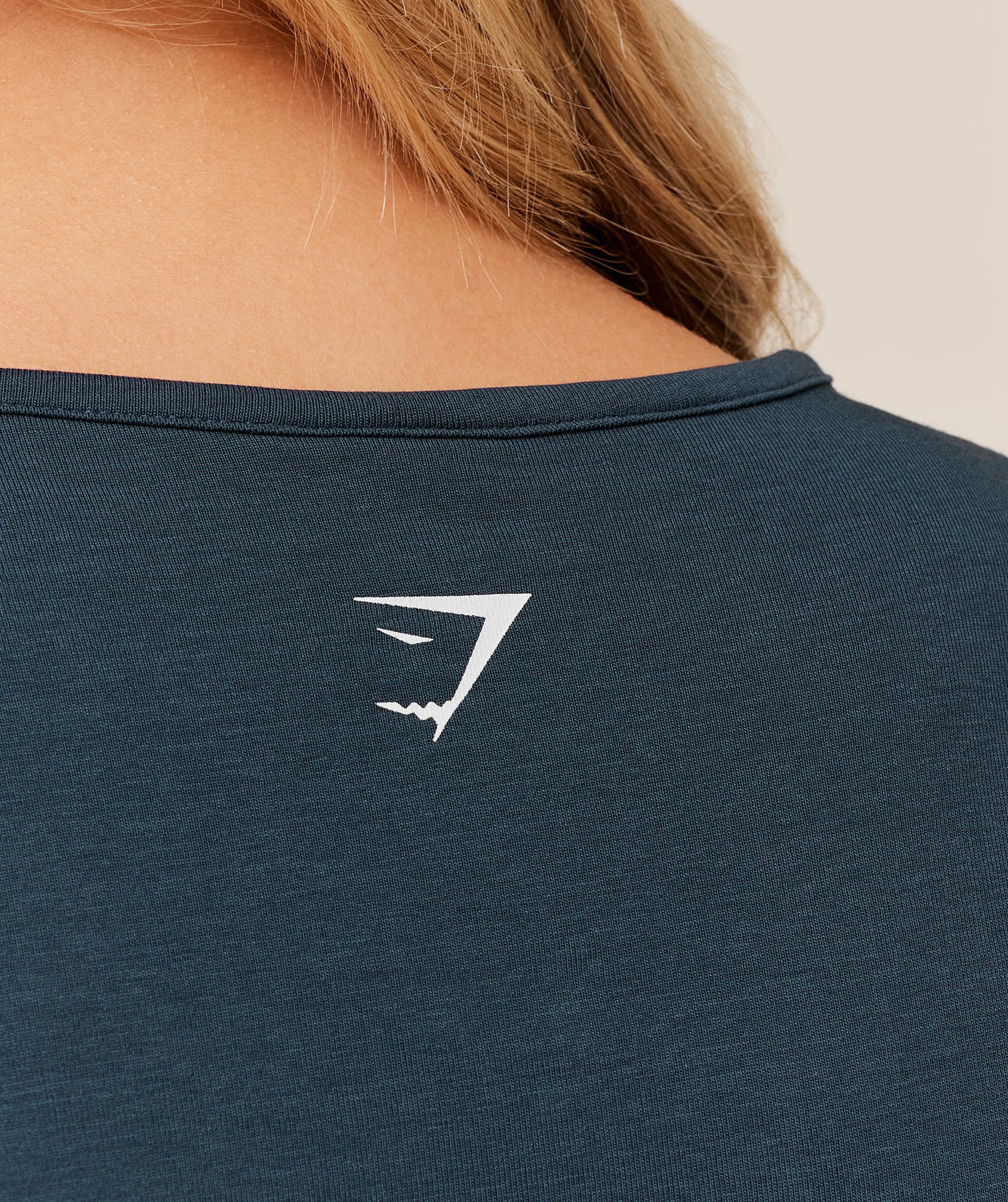 gymshark-worn-crest-graphic-baby-tee-ss-tops-blue-ss26