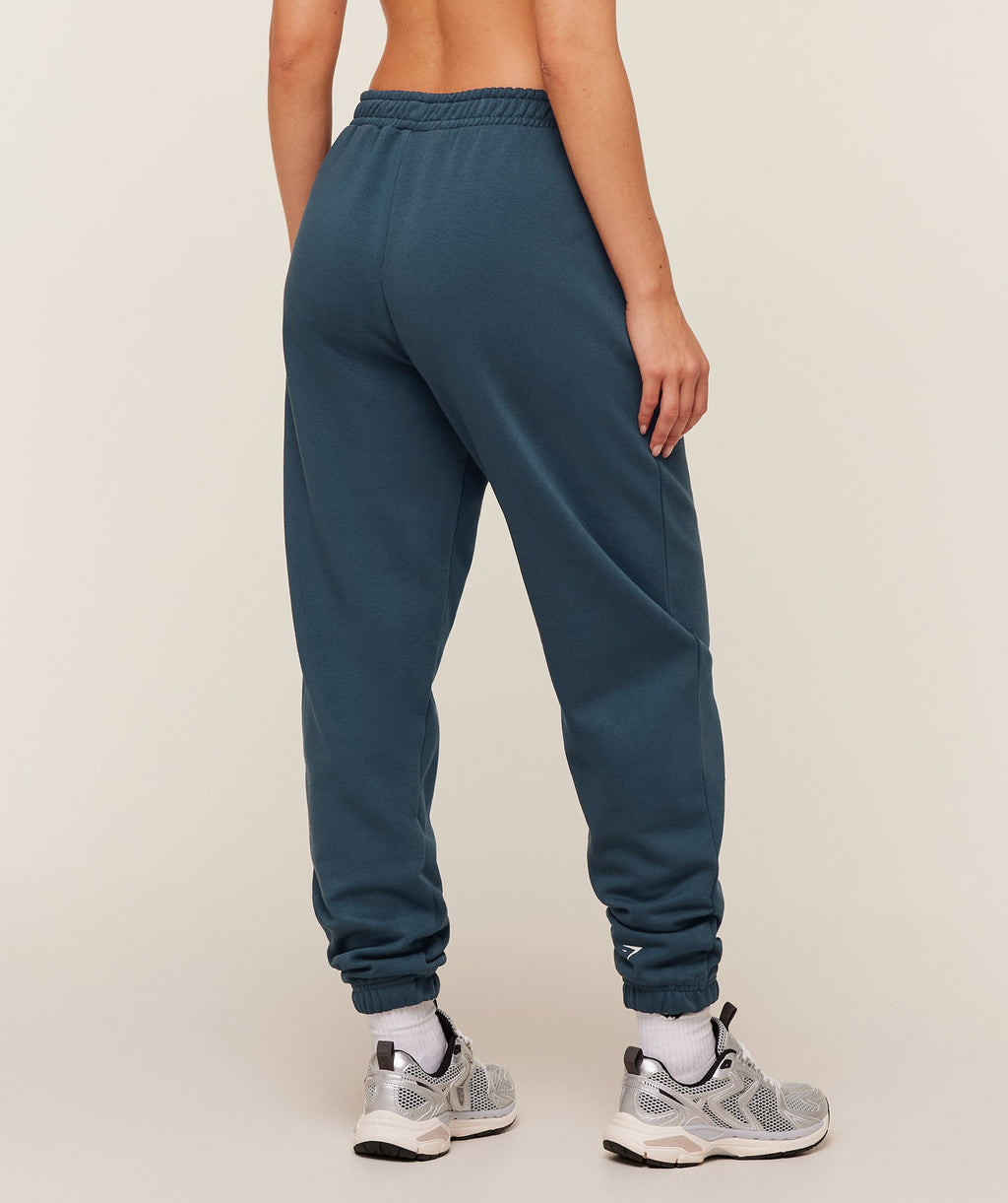 gymshark-worn-crest-graphic-jogger-pants-blue-ss26